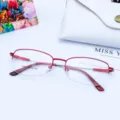 Detailed shot of women's red semi-rimless metal glasses frame with flexible memory temples. - Red