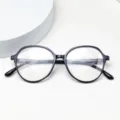 Detailed view of lightweight TR90 optical glasses frame, clear lenses and temple markings. - Bright Black