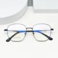 Close-up detail of lightweight beta-titanium polygonal optical glasses frame with sleek finish. - Bright Black
