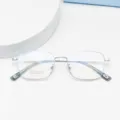 Close-up detail of silver metal square eyeglasses frame, lightweight optical eyewear. - Silver White