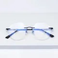 Lunettes de vue sans monture en titane design avec verres coupés polygonaux et branches bicolores. - Noir