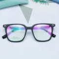 Close-up detail of vintage black square TR90 optical glasses frame with clear lenses. - Matte Black