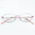 Close-up detail of pink metal eyeglasses frame, lightweight beta-titanium optical design. - Pink