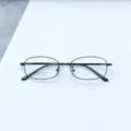 Detailed view of black metal optical eyeglass frame, small square frame style for daily wear. - Bright Black