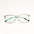Detailed view of stylish half-rim browline optical glasses frame with clear and metal design. - Cold Tea