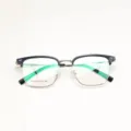 Detail view of classic semi-rimless eyeglasses frame with black browline and clear demo lenses. - Black & Gold