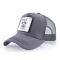 Grey mesh trucker hat for men featuring a stylish embroidered raccoon animal patch design. - Adjustable / Gray