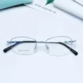 Detailed view of the oval semi-rimless metal eyeglasses frame for women, lightweight design. - Silver White