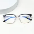 Closeup detail of the black and gold browline glasses frame, highlighting exquisite craftsmanship. - Bright Black Gold