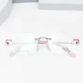 Montatura per occhiali senza montatura in titanio elegante con stanghette rosa per tutti. - Rosa