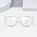Closeup of clear multi-sided fashion eyeglasses frame with silver metal bridge and blue light lens. - Clear White
