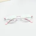Detail shot of pink oval titanium eyeglass frame, lightweight optical glasses for daily wear. - Pink