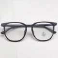 Detailed view of the black TR optical glasses frame, highlighting the anti-blue light demo lens. - Bright Black