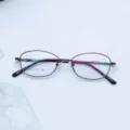 Close-up detail view of the women's metal optical frame glasses in elegant purple red finish. - Purple / Plain