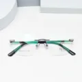 Detailansicht der rahmenlosen Titan-Brille, diamantgeschliffene Gläser und grüne Bügel. - Gunmetal Grau