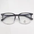 Close-up of TR90 optical glasses frame with gradient black and clear design, anti-blue light. - Gradient Black
