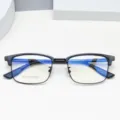 Men's half-rim browline prescription eyeglasses frame featuring clear anti-blue light lenses. - Black Black
