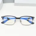 Close-up detail of men's TR90 browline glasses frame with anti-blue light lenses and clear specs. - Black and Gray