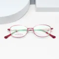 Detail view of lightweight women's metal optical glasses frame in red, elegant business style. - Red