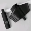 Compact black folding sun umbrella with capsule case, UV protection for daily outdoor travel. - Manual Open UV Black
