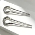Detailed close-up of minimalist alloy U-shaped hair fork, sleek curved design for elegant buns. - 2 Pieces/Pack / Gunmetal