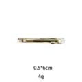 Detail shot of a Korean style gold metal hair clip with clear polka dot design, 0.5x6cm. - 6cm / Clear White