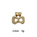 Detailed close-up of mini gold alloy hair claw clip, textured bow design, compact 2.5cm size. - Double Ring Bowknot Style (1162-19) / Gold
