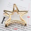 Gold star hair claw clip detail shot, minimalist metal hair accessory for daily styling. - Curved Pentagon Shape