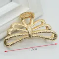 Close-up detail of the elegant gold metal hair claw clip featuring a stylish hollow design. - Triple-Wave Large Bow Claw Clip