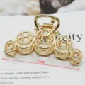 Minimalist gold metal hair claw clip with hollow smiley face design, large size accessory. - Five-Loop Smiley Face 7cm Gold