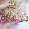 Large gold zinc alloy hair claw clip with hollow wing design, minimalist adult styling accessory. - Multi-Leaf Butterfly