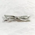 Silver bow hair clip for women, metal spring barrette for daily styling and elegant buns. - Silver Bow