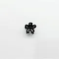 Detailed view of a black floral mini hair claw clip, perfect for styling hair securely. - Hollow Flower / Black