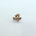 Golden metal bow mini hair claw clip detail, exquisite metallic hair accessory close up. - Bow / Gold
