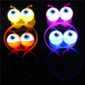 Close-up detail shot of glowing eyeball headbands with LED lights, perfect for party props. - Red