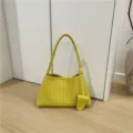Close-up of yellow woven leather shoulder bag showing intricate intrecciato details. - Lemon Yellow