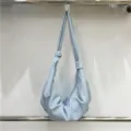 Detailed view of the soft leather pleated hobo bag showing texture and slouchy design. - Blue