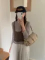 Stylish neutral shoulder bag worn by model, trendy everyday crossbody accessory for women. - Apricot