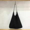 Detail view of black suede hobo shoulder bag, large capacity slouchy design, autumn accessory. - Matte Black