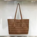 Brown hollow-carved tote bag detailed view, large capacity shoulder handbag with geometric patterns. - Brown
