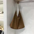 Soft leather slouchy brown shoulder tote bag detail showcasing large capacity and minimalist everyday style. - Brown