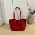 Large capacity suede tote bag detail view, featuring minimalist red design with a cute hanging charm. - Red