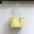 Detailed close-up shot of yellow woven leather shoulder tote bag, soft hobo handbag for daily use. - Lemon Yellow