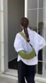 Detail shot of the green crescent shoulder bag, casual moon bag worn by model daily. - Green Fabric