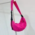 Bright pink nylon crescent dumpling crossbody bag detail, adjustable black strap, zipper. - Rose Red - Waterproof