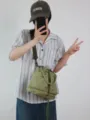 Casual olive green oxford cloth bucket bag daily wearing scene detail, stylish for commuting. - Bean Green
