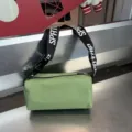 Green cylindrical waterproof crossbody bag with wide letter-printed strap for casual daily wear. - Green