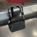Black waterproof cross-body shoulder bag with wide letter strap for casual daily use. - Black