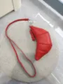Red soft leather croissant bag, stylish crescent coin purse with long strap and metal hardware. - Red