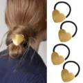 Gold metal heart hair tie detail view showing ponytail holder accessory design and texture. - Heart Decor Hair Tie Set (Set 42) / Set of 4 / Gold